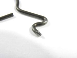 Zużyta końcówka sprężyny napędu pompy oleju pilarki STIHL